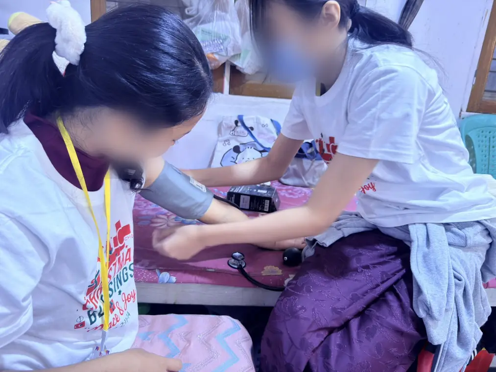 VAI student volunteers, peer practice: manual blood pressure, Mandalay
