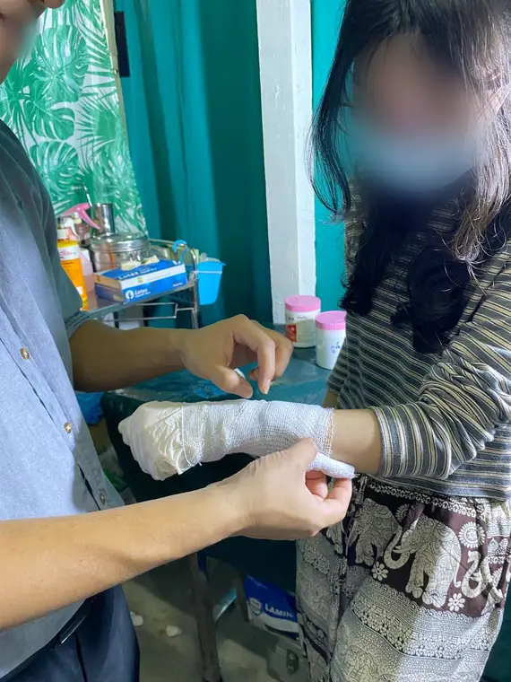 VAI student volunteers, applying a wrist bandage, Yangon