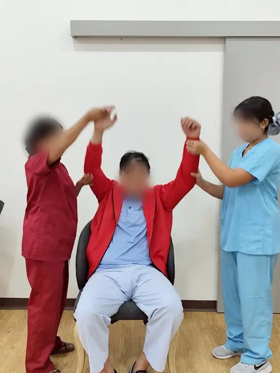 VAI student volunteers, assisted arm and shoulder exercises, Bangkok